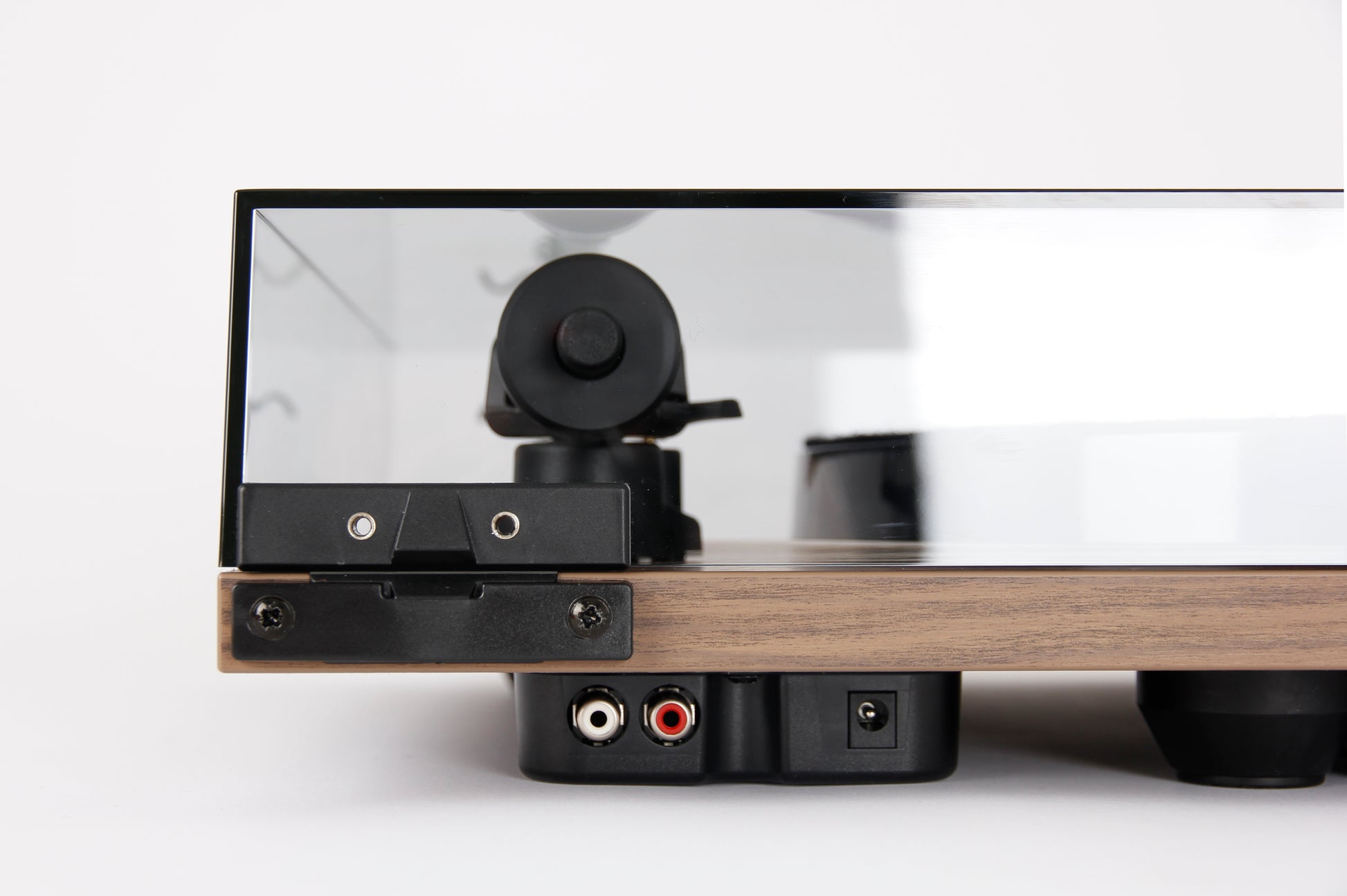 Product image for the rear of a Rega Planar 1 Plus turntable in Walnut finish showing the RCA output sockets and power socket