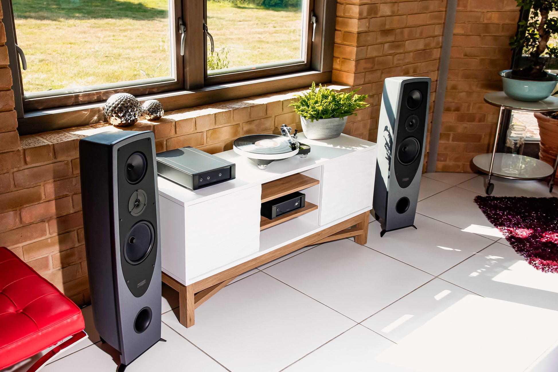 Lifestyle Image of a pair of Rega AYA floorstanding speakers
