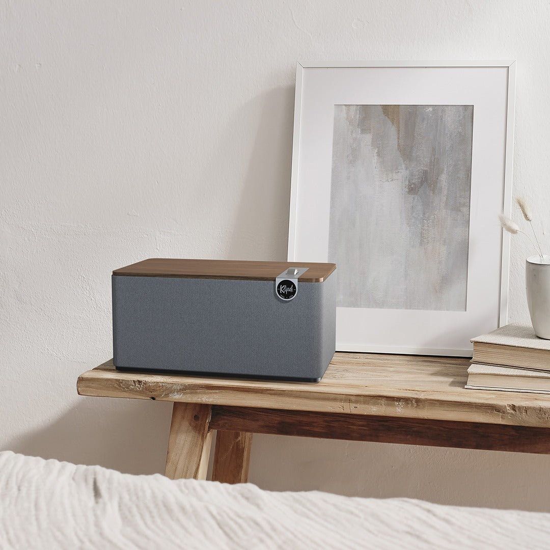Lifestyle Image of the Klipsch Three Plus Bluetooth Speaker in Walnut